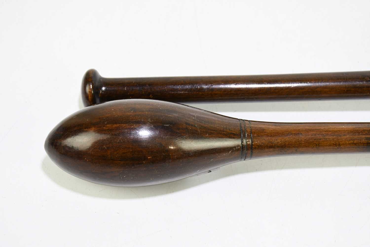 A pair of turned and stained treen exercise weights / Indian Clubs, length 47cm. - Image 2 of 3