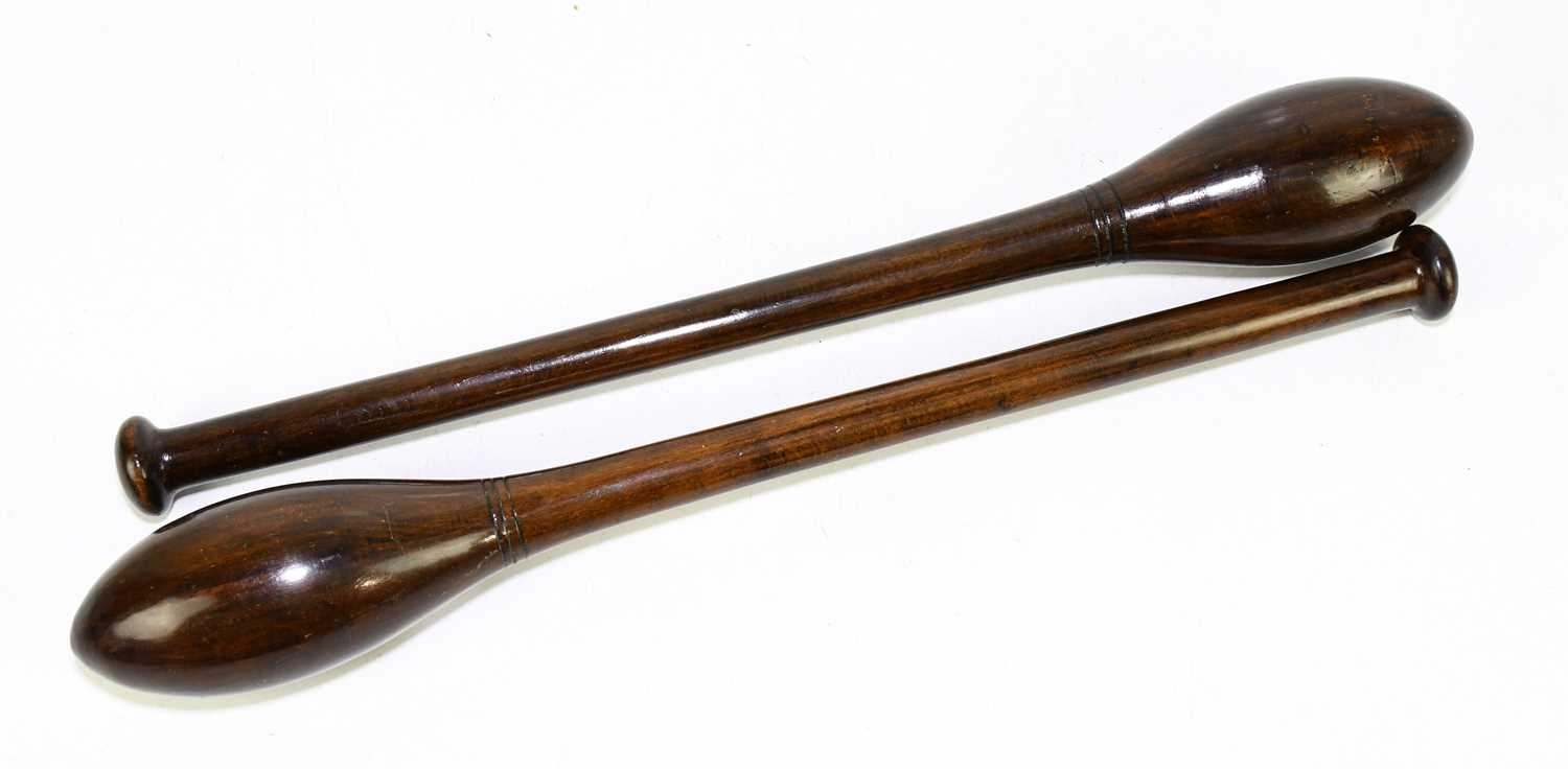 A pair of turned and stained treen exercise weights / Indian Clubs, length 47cm.