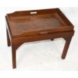 A mahogany butler's tray on associated stand terminating on block supports, width 73cm.