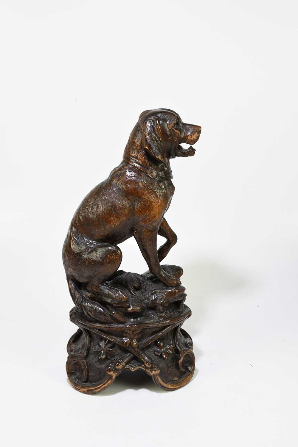 A late 19th century Black Forest large carved soft wood model of a seated dog, on naturalistic - Image 5 of 6