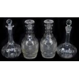 A pair of cut glass decanters with faceted details, height 26cm, together with a pair of cut and