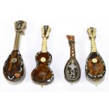 A collection of four tortoiseshell veneered miniature musical instruments, comprising three