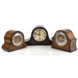 Three early 20th century oak cased mantel clocks to include a Napoleon hat shaped example with