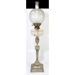 A late 19th century/early 20th century silver plated oil lamp with bulbous etched glass shade, cut