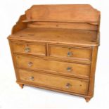 A Victorian pine chest with two short and two long drawers with moulded glass handles, on turned