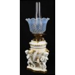 MOORE BROTHERS; a 19th century ceramic oil lamp with opaque wrythen decorated shade above a