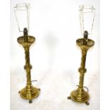 A pair of brass table lamps.