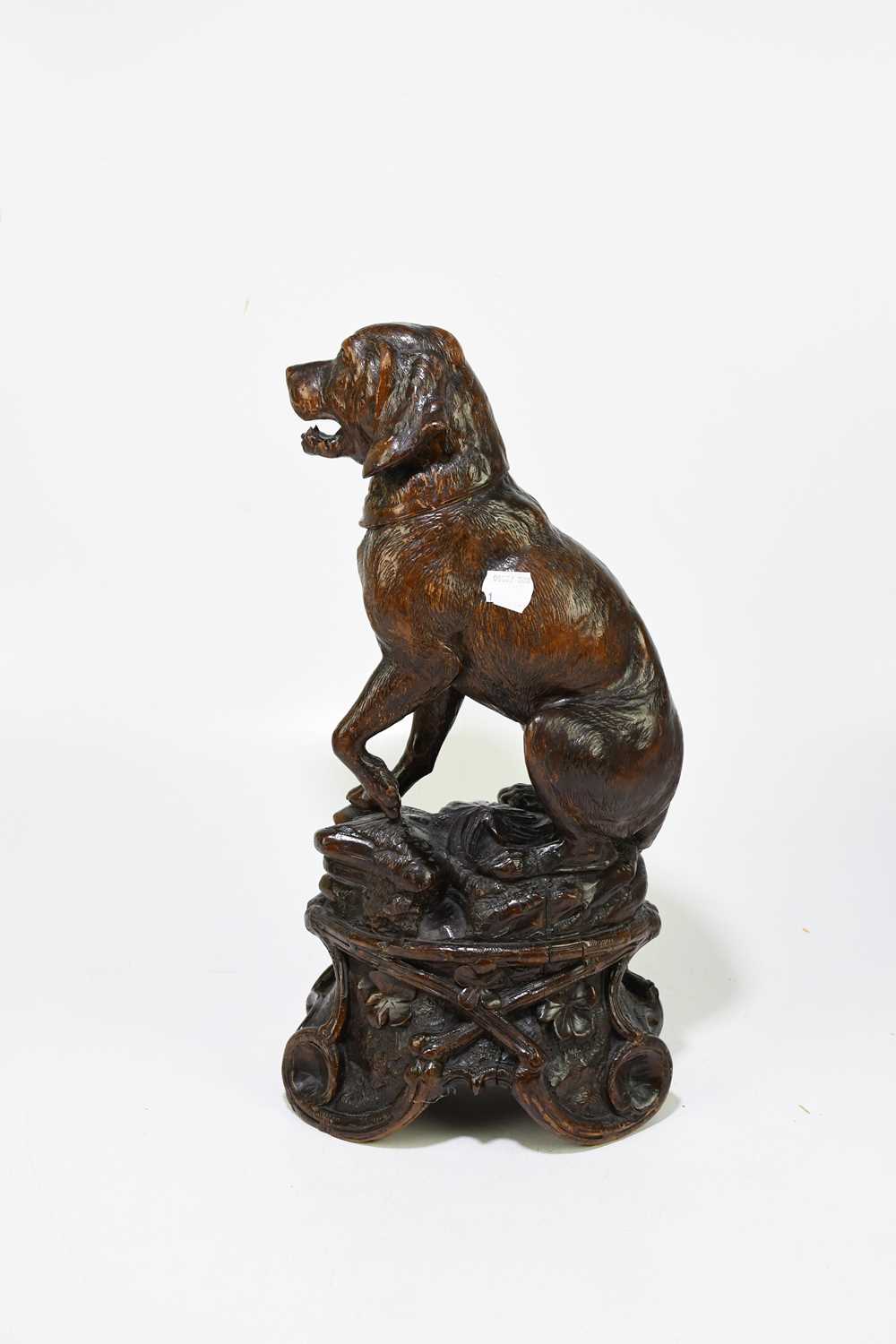 A late 19th century Black Forest large carved soft wood model of a seated dog, on naturalistic - Image 3 of 6