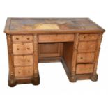 A 19th century oak knee-hole desk with brown leather inset top above an arrangement of nine