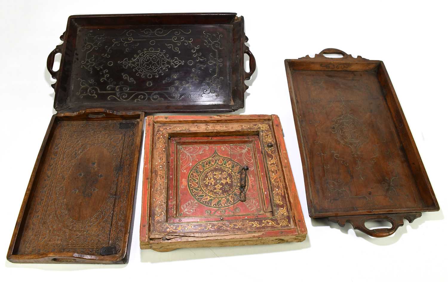 Three Indian hardwood trays and a painted small square sectioned window panel (4).