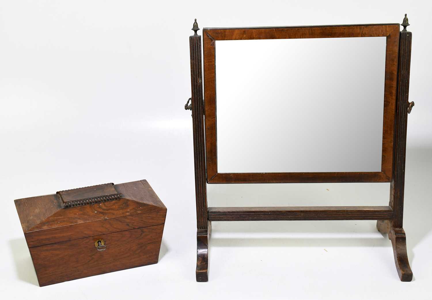 A mahogany tea caddy of sarcophagus form, together with a swing toilet mirror (2)