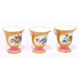 SEVRES; a set of three hand painted ice cups, each with hand painted floral detail inside a shaped