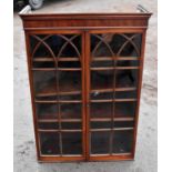 An early 19th century mahogany bookcase top section with moulded cornice above a pair of astragal