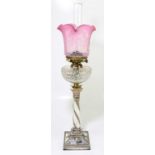 A 19th century silver plated oil lamp with etched cranberry shade and decorated with thistles