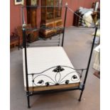 A black painted cast metal four poster bedstead.