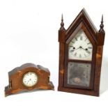 An Edwardian inlaid mahogany mantel clock of shaped arched form, the enamelled dial set with Roman