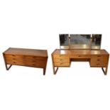 UNIFLEX; a teak mirror back dressing table, with an arrangement of seven drawers on turned