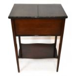 A 1950s mahogany sewing cabinet, with pull out panels enclosing sliding compartments and storage