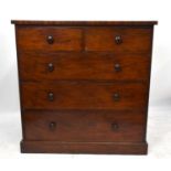 A Victorian mahogany chest of two short and three long drawers, on plinth base, with turned wood