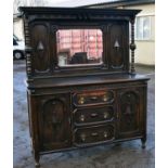 An early 20th century oak mirror back sideboard in the Jacobean style, with the bevelled mirror
