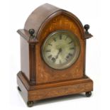 An Edwardian rosewood and inlaid lancet shaped mantel clock with Roman numerals to the silvered dial