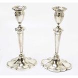 A pair of silver plated candlesticks of oval form, with cast decoration, height 30cm.