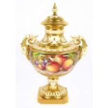 JOHNSON FOR ROYAL WORCESTER; a twin handled pedestal lidded urn vase, painted with fruit, signed,