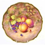 JOHN FREEMAN FOR ROYAL WORCESTER; a hand painted scalloped edge cabinet plate, decorated with fruit,