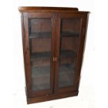 A 1920s oak two door bookcase, on plinth base, height 113cm, width 75cm.