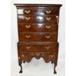 An 18th century and later walnut chest on stand, the upper with two short and three graduated long