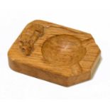 ROBERT THOMPSON (MOUSEMAN) WORKSHOP; a carved light oak ashtray, length 10cm.