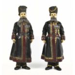 A pair of Russian cold painted metal figures of Cossacks in the manner of Faberge, modelled as