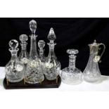 A collection of six cut glass decanters and stoppers, various designs, height of tallest 38cm, on an