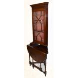 An early 20th century mahogany freestanding corner cabinet with moulded cornice above the astragal