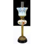 An early 20th century brass oil lamp with veined Vaseline glass shade and painted milk glass