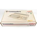 COMMODORE 500; a boxed computer console with two controllers and six arcade games.