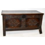 An 18th century carved oak coffer, with carved panel front on block legs, width 130cm, depth 60cm,