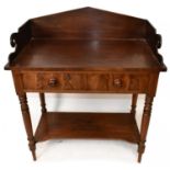 A Victorian mahogany wash stand with raised galleried back above two drawers and undertier shelf, on
