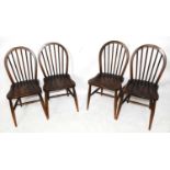 A set of four reproduction comb back kitchen chairs.