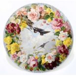 A large and impressive hand painted 19th century circular wall charger, decorated with birds in