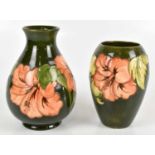 MOORCROFT; two vases decorated in the 'Hibiscus' pattern to include a baluster shaped vase, height