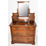 An Edwardian walnut dressing table, with bevelled mirror and two drawers above three long drawers,