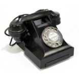 A vintage bakelite telephone.