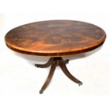 A Victorian inlaid walnut oval loo table, with quarter veneered top on turned column and reeded