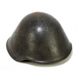 A post World War II East German army helmet with liner and chin strap.
