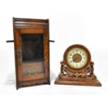 A Victorian carved oak mantel time piece, height 19cm, with an oak smoker's cabinet (2)Condition