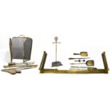 A 19th century brass adjustable fender, together with assorted fireside items to include a companion