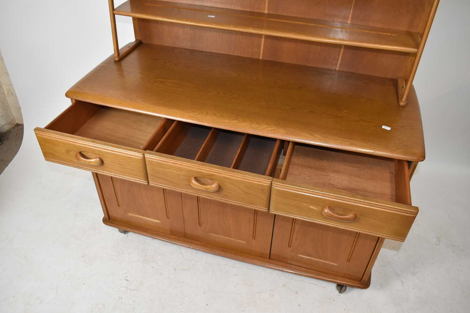 A 1970s light oak dining suite comprising drop-leaf dining table on block legs, four spindle arch - Image 4 of 8