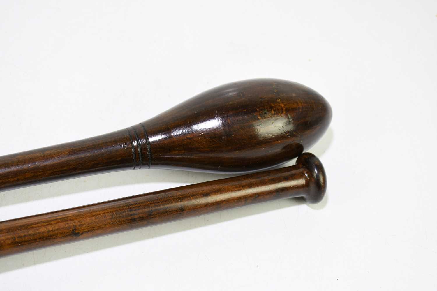 A pair of turned and stained treen exercise weights / Indian Clubs, length 47cm. - Image 3 of 3