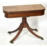 An early 19th century mahogany card table raised on turned central column to four square sectioned